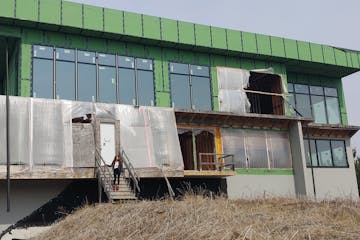 A divorce and financial problems have stopped work on this 15,000-square-foot house in Rochester Township. Fed-up neighbors want it torn down.