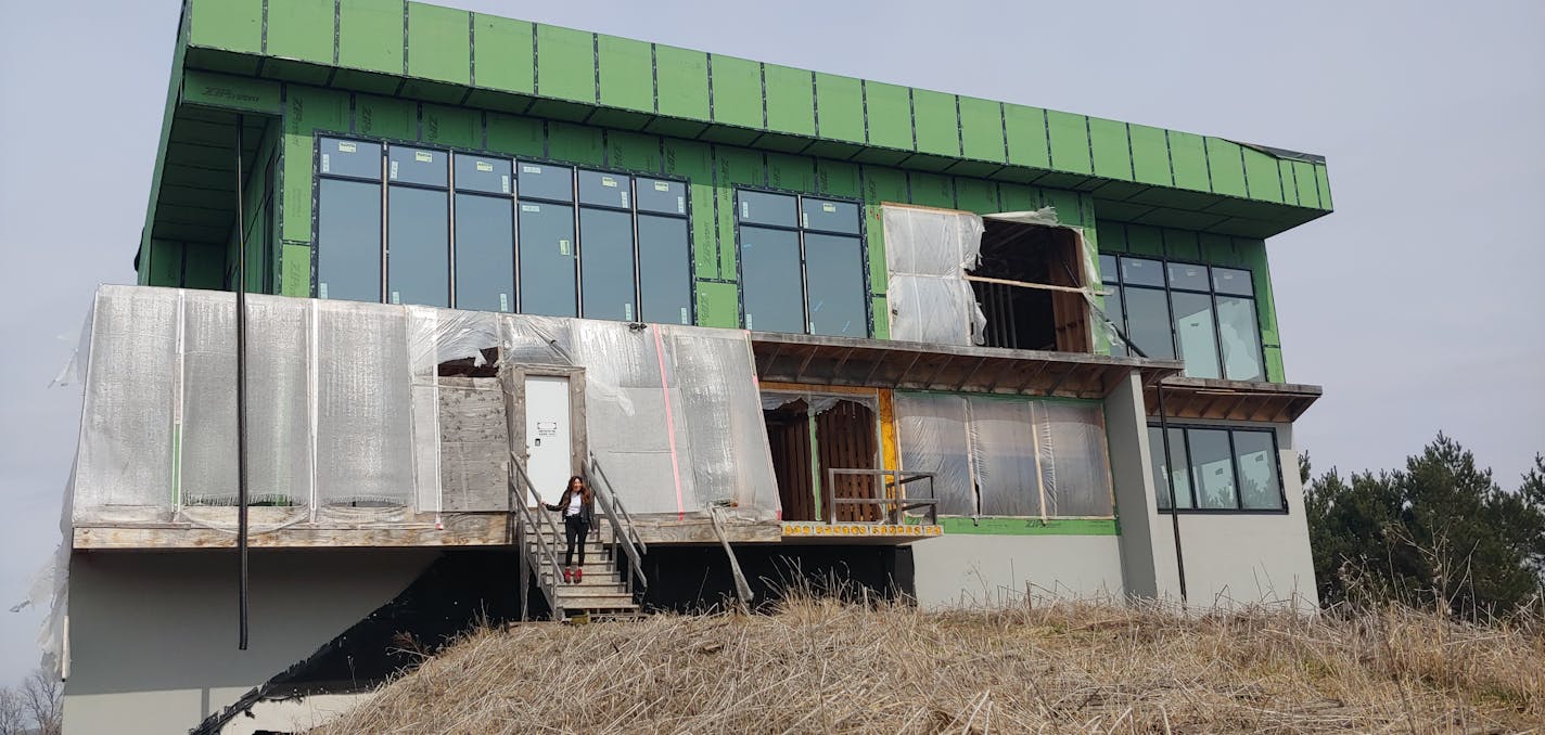 A divorce and financial problems have stopped work on this 15,000-square-foot house in Rochester Township. Fed-up neighbors want it torn down.