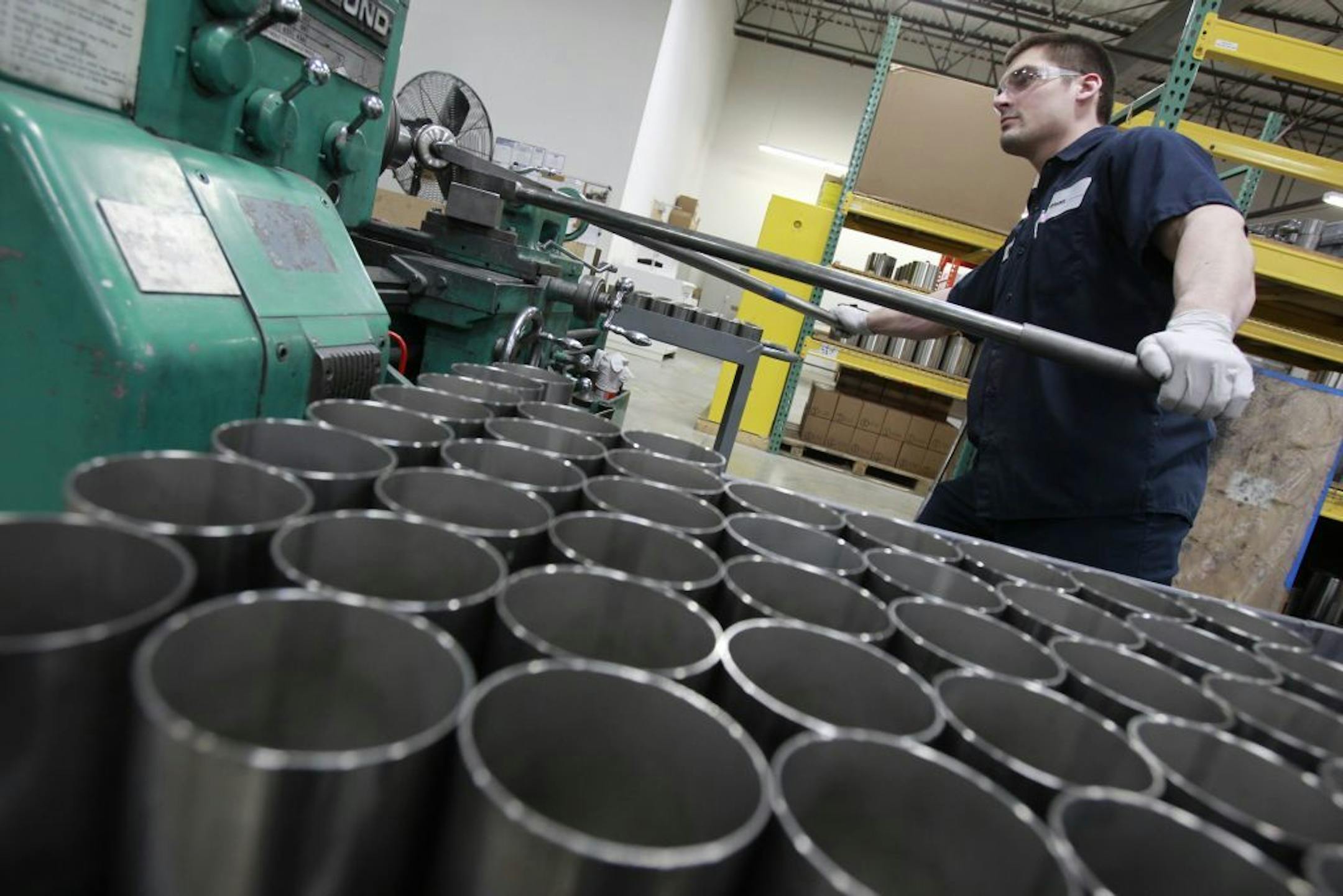 Nick Davis an employee at Fire Away Inc, prepared a caster that will be used to hold a fire suppression. ORG XMIT: MIN2013041715404523