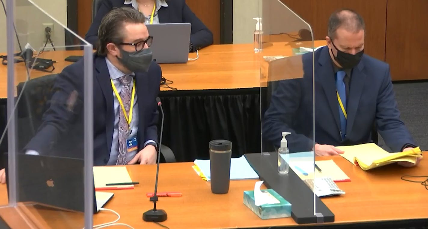 In this image taken from video, defense attorney Eric Nelson, left, and defendant former Minneapolis police officer Derek Chauvin, right, confer before Hennepin County Judge Peter&nbsp;Cahill presides over jury selection in the trial of Chauvin, Monday, March 22, 2021, at the Hennepin County Courthouse in Minneapolis. Chauvin is charged in the May 25, 2020, death of George Floyd. (Court TV via AP, Pool)