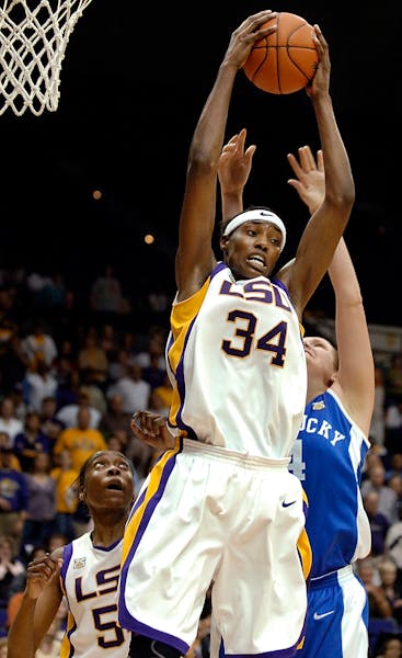 LSU's Sylvia Fowles (34) pulls down the final rebound to preserve the win, in front of Kentucky's Sarah Elliott, right, as LSU's Ashley Thomas, left, 