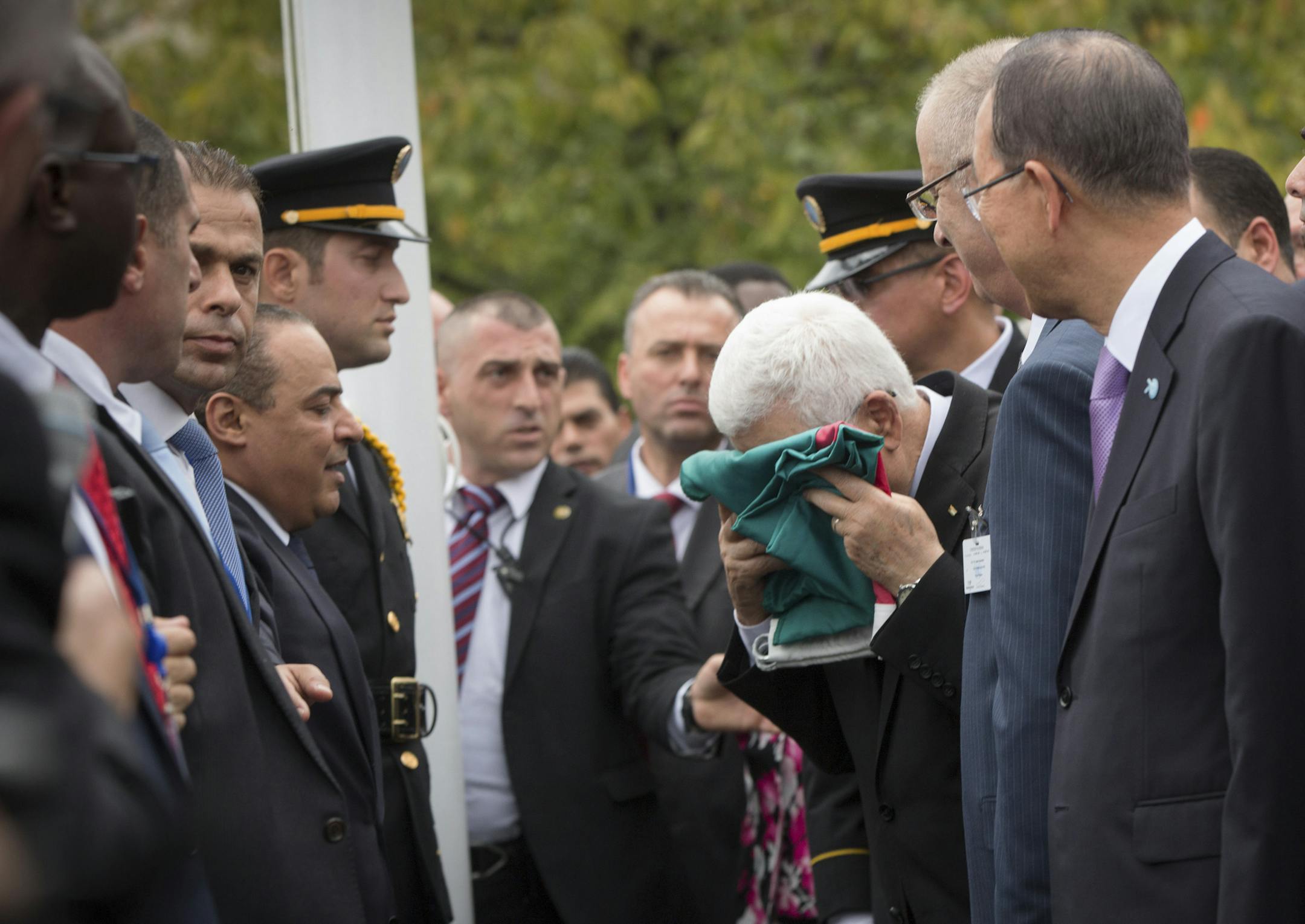Mahmoud Abbas, president of the Palestinian Authority, kisses the Palestinian flag before it is raised for the first time in the Rose Garden outside the United Nations, Sept. 30, 2105. Demonstrating a new level of tension with Israel, Abbas declared Wednesday that it was no longer bound by the 1995 Oslo Accords that formed the basis for a two-state solution to the Israeli-Palestinian conflict. (Michael Appleton/The New York Times)