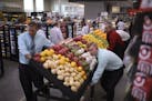A crew rolled a display of fresh produce to the front of the store Monday afternoon.