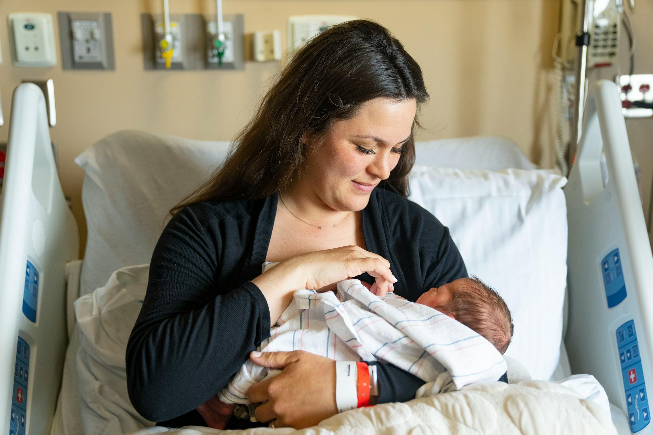 Emily McDonagh holds her newborn daughter, Clare, Thursday, March 24, 2022 at Maple Grove Hospital in Maple Grove, Minn. Clare was born March 23, 2022.
