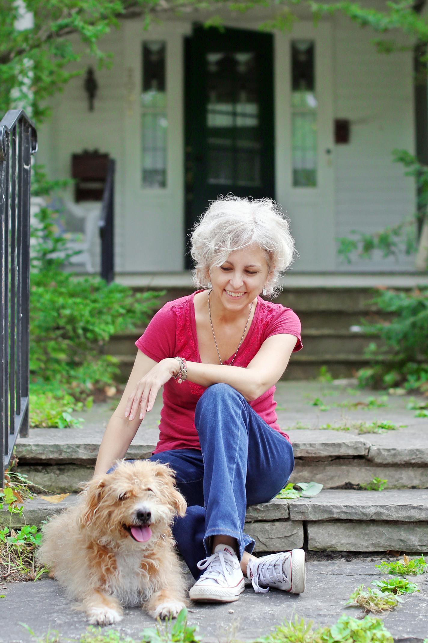 (Photo provided by Amy Gibbon.) Kate DiCamillo, with her dog, Henry, in September. Henry, a cairn terrier/poodle mix, died in December. "It is the lesson of life just made so explicit," she said.