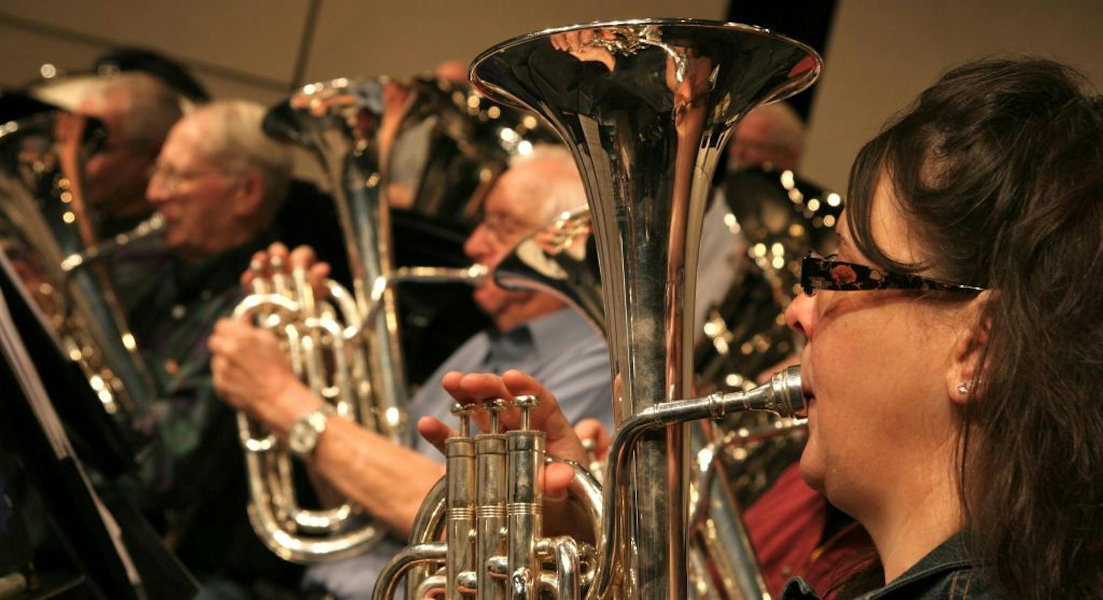 PHOTO BY MARIA BACA. Alto horn player Lora Ukaegbu and other members of the Lake Wobegon Brass Band practice for their winter concert series. In its upcoming concerts, the group is playing "Beyond Far Horizons," a specially commissioned piece by renowned British composer Philip Wilby, written in the tradition of the British Brass band. Despite the name, the group is not affiliated with the Minnesota Public Radio show or Garrison Keillor.