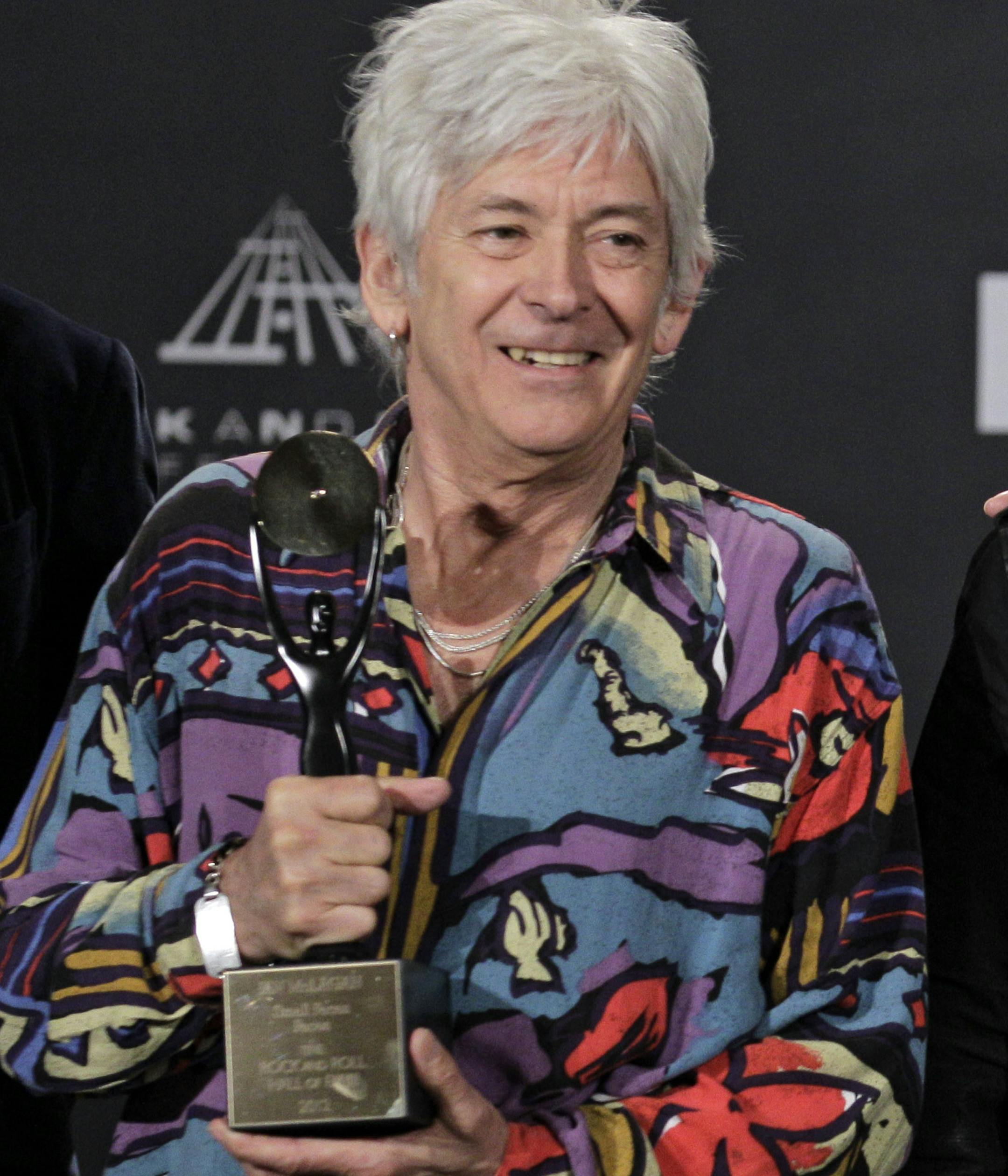 FILE - In this April 14, 2012 file photo, Small Faces/Faces members, from left, Ian McLagan, Kenney Jones and Ronnie Wood, appear in the press room after induction into the Rock and Roll Hall of Fame Rock and Roll Hall of Fame, in Cleveland. Rolling Stones collaborator and Faces keyboardist McLagan, 69, has died. A statement on his official website said the musician died Wednesday, Dec. 3, 2014, in Austin after suffering a stroke a day earlier. (AP Photo/Amy Sancetta, File)