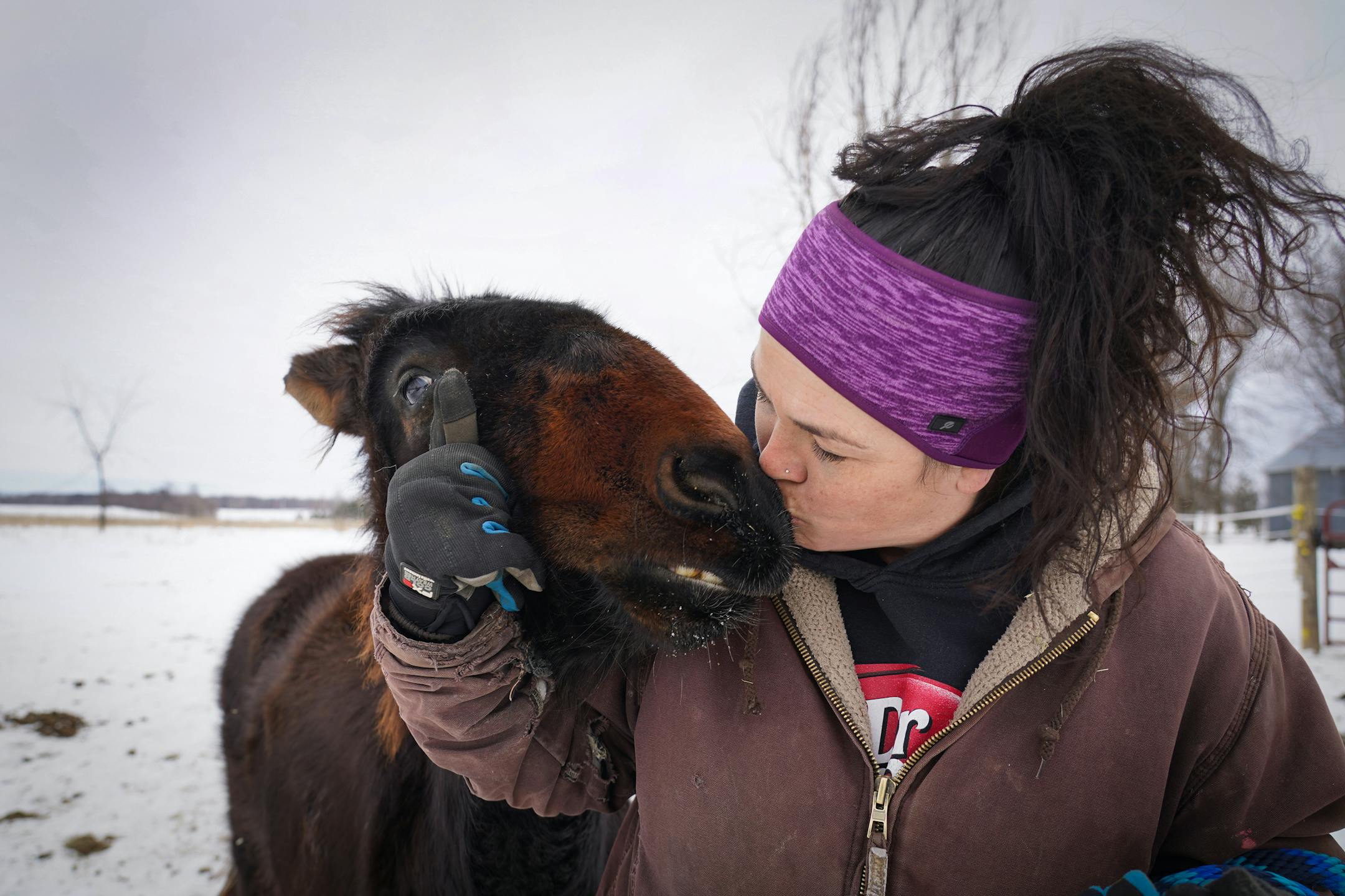 Kym Garvey gives Lemon the mule a kiss on the snout. Lemon was born with wry nose which makes her look different from other mules, causing them to shun her.