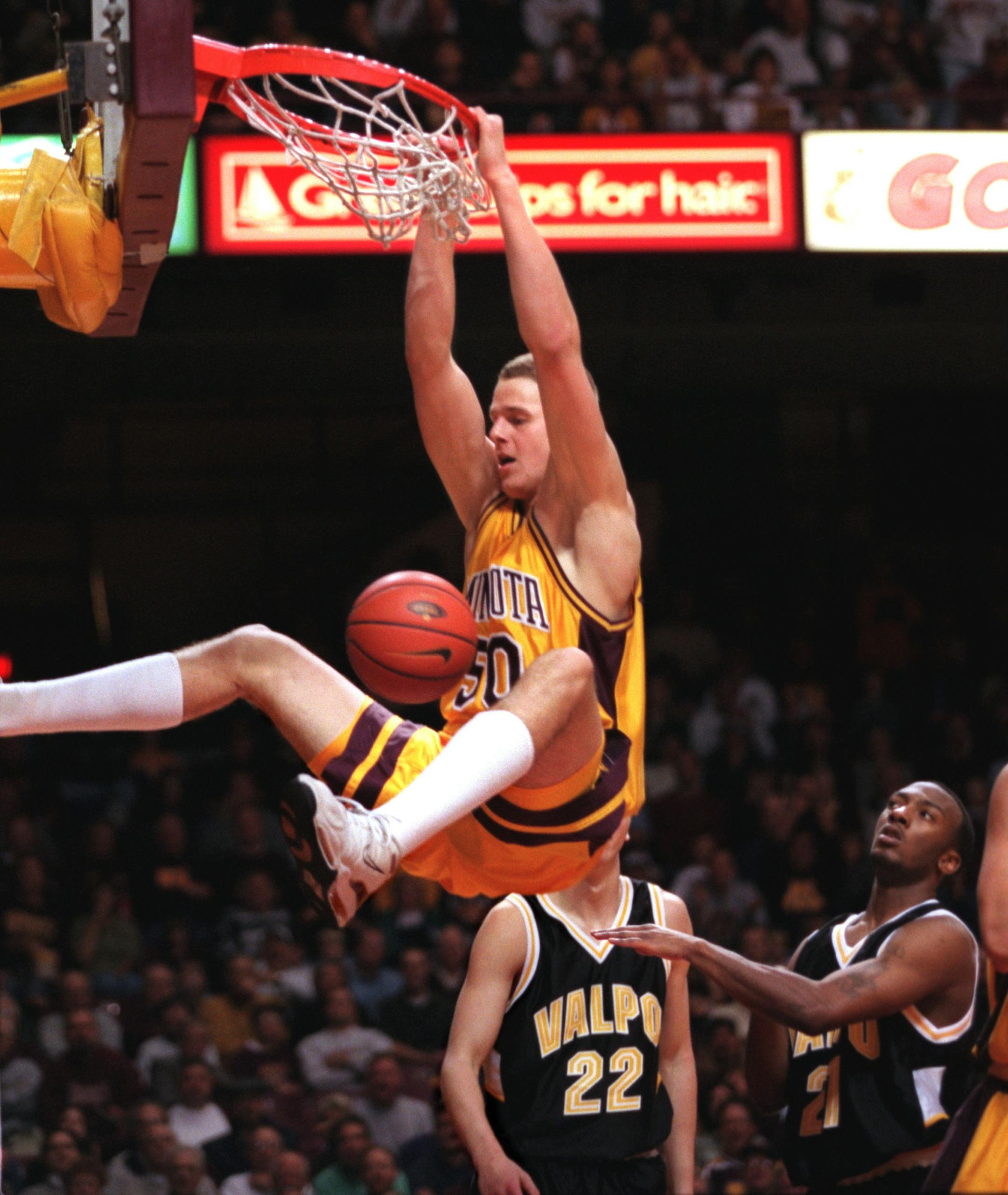Gophers vs. Valparaiso basketball - Minneapolis - Saturday, December 4 1999 -- Joel Przybilla stuffs home two of his eighteen points against Valparaiso as Valparaiso�s Raitis Grafs #22 and Jared Nuness look on.
