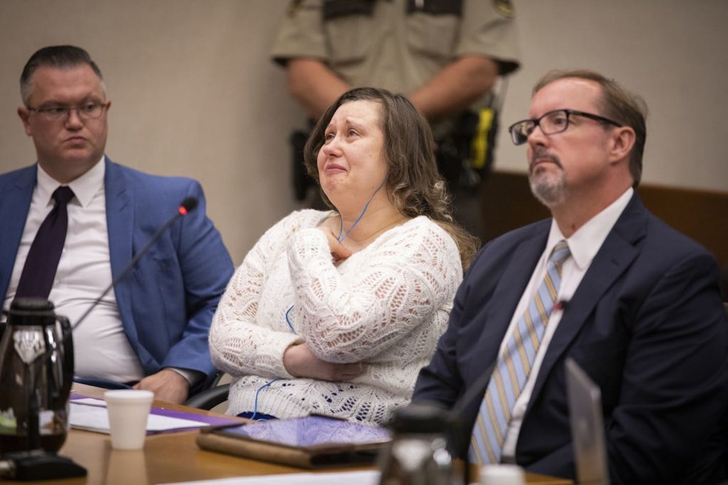 Nataliia Karia, center, with her lawyers Brock Hunter, right, and Ryan Else, reacts during her sentencing hearing.