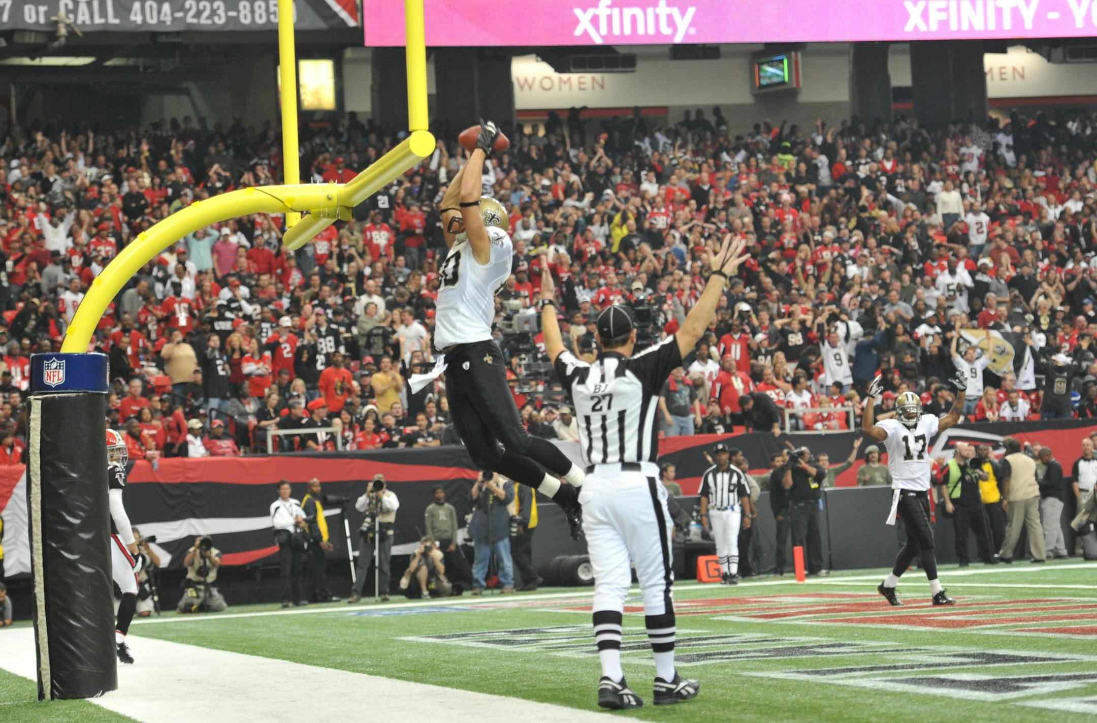 **RAW FILE**New Orleans Saints tight end Jimmy Graham (80) throws the ball through the goal post after he caught a touchdown pass during the first half of an NFL football game against the Atlanta Falcons Sunday, Nov. 13, 2011, in Atlanta. (AP Photo/Rich Addicks)
