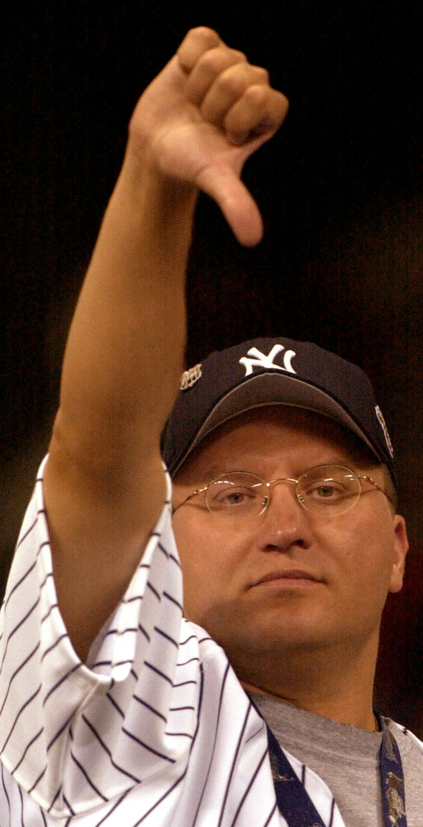 Baseball fan Dave Jepson of Milwaukee displays a thumbs-down after the All-Star Game was called at the end of the 11th inning with the score tied at 7-7 in Milwaukee, Tuesday, July 9, 2002. (AP Photo/Charlie Neibergall) ORG XMIT: ASG150