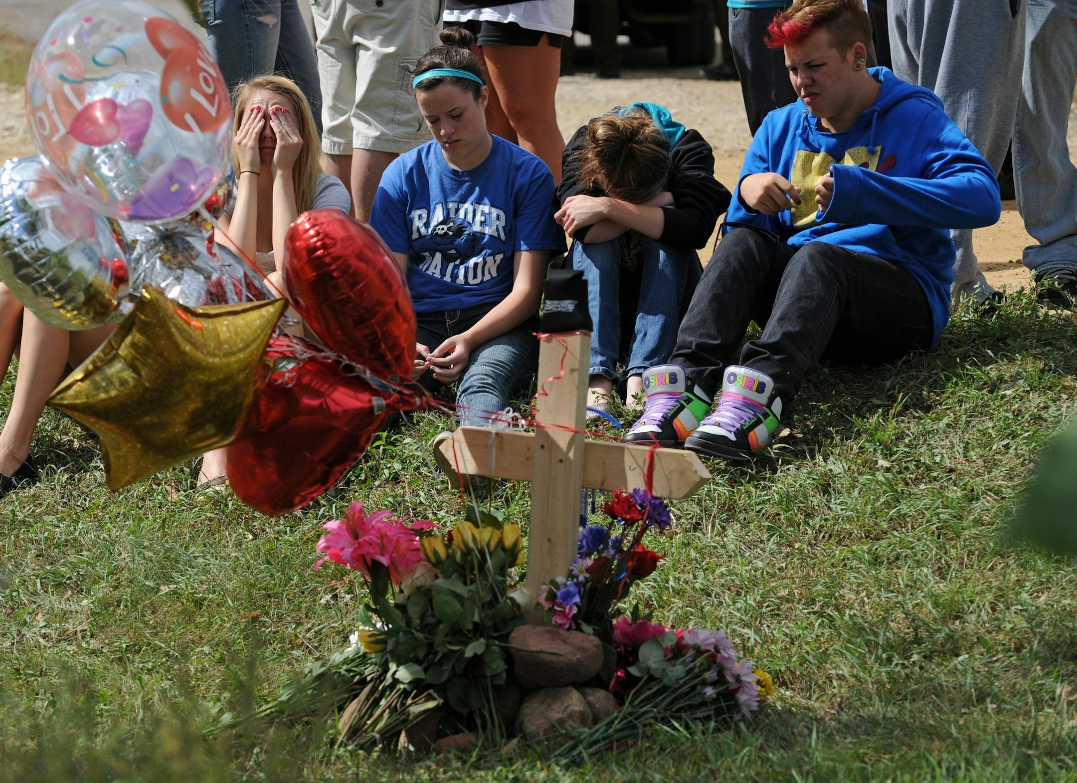 A car and a pickup truck collided on a gravel road south of Hastings, killing high school student Maddy R. Sake, 16, and injuring three young people, authorities and the Hastings School District said Friday. Friends and class mates grieved at the crash site by a memorial for their friend Maddy Sake
