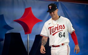 Minnesota Twins first baseman Jose Miranda (64) models a new team jersey.