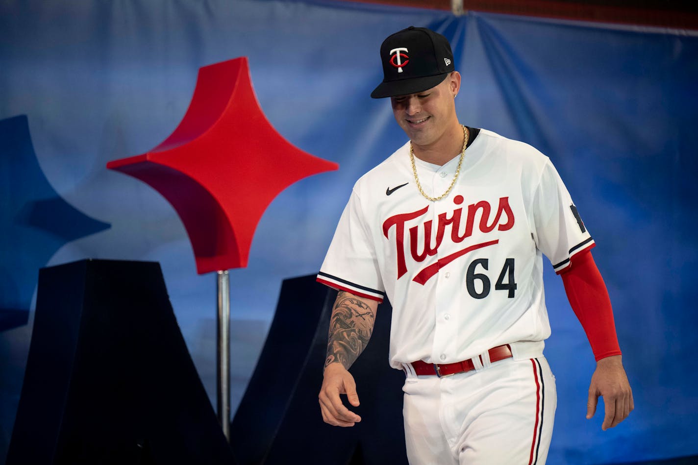 Minnesota Twins first baseman Jose Miranda (64) models a new team jersey.