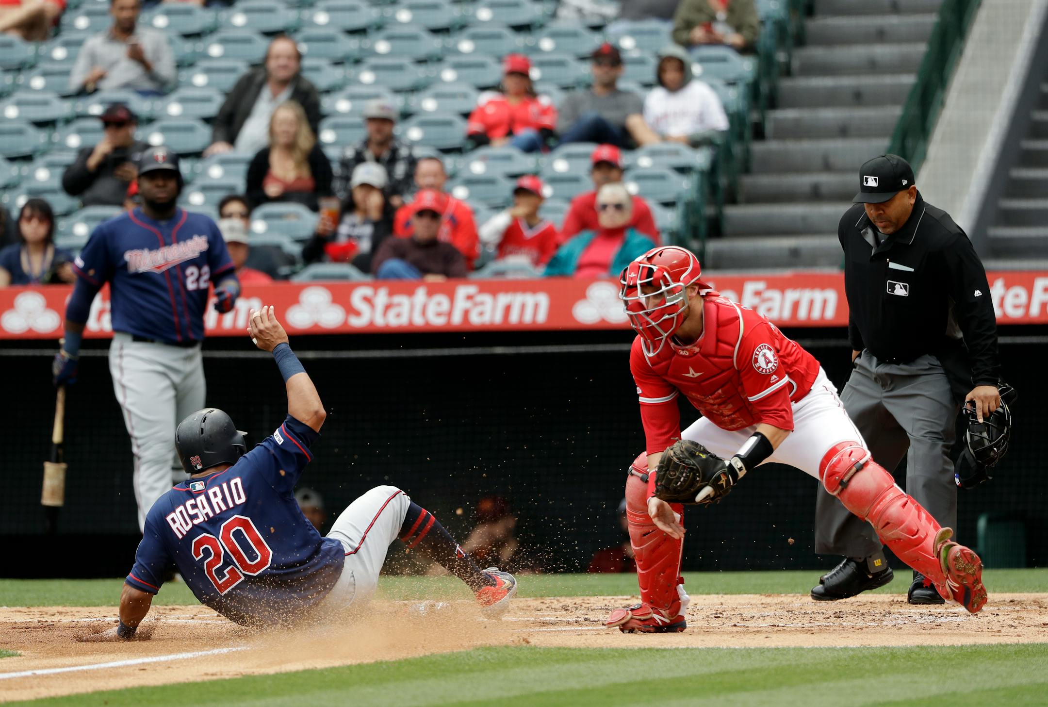Eddie Rosario scored past Angels catcher Jonathan Lucroy on a sacrifice fly ball from Luis Arraez during the second inning