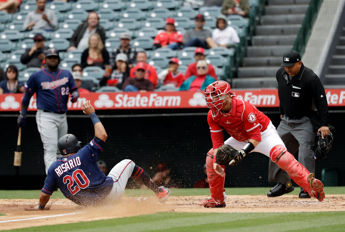 Eddie Rosario scored past Angels catcher Jonathan Lucroy on a sacrifice fly ball from Luis Arraez during the second inning