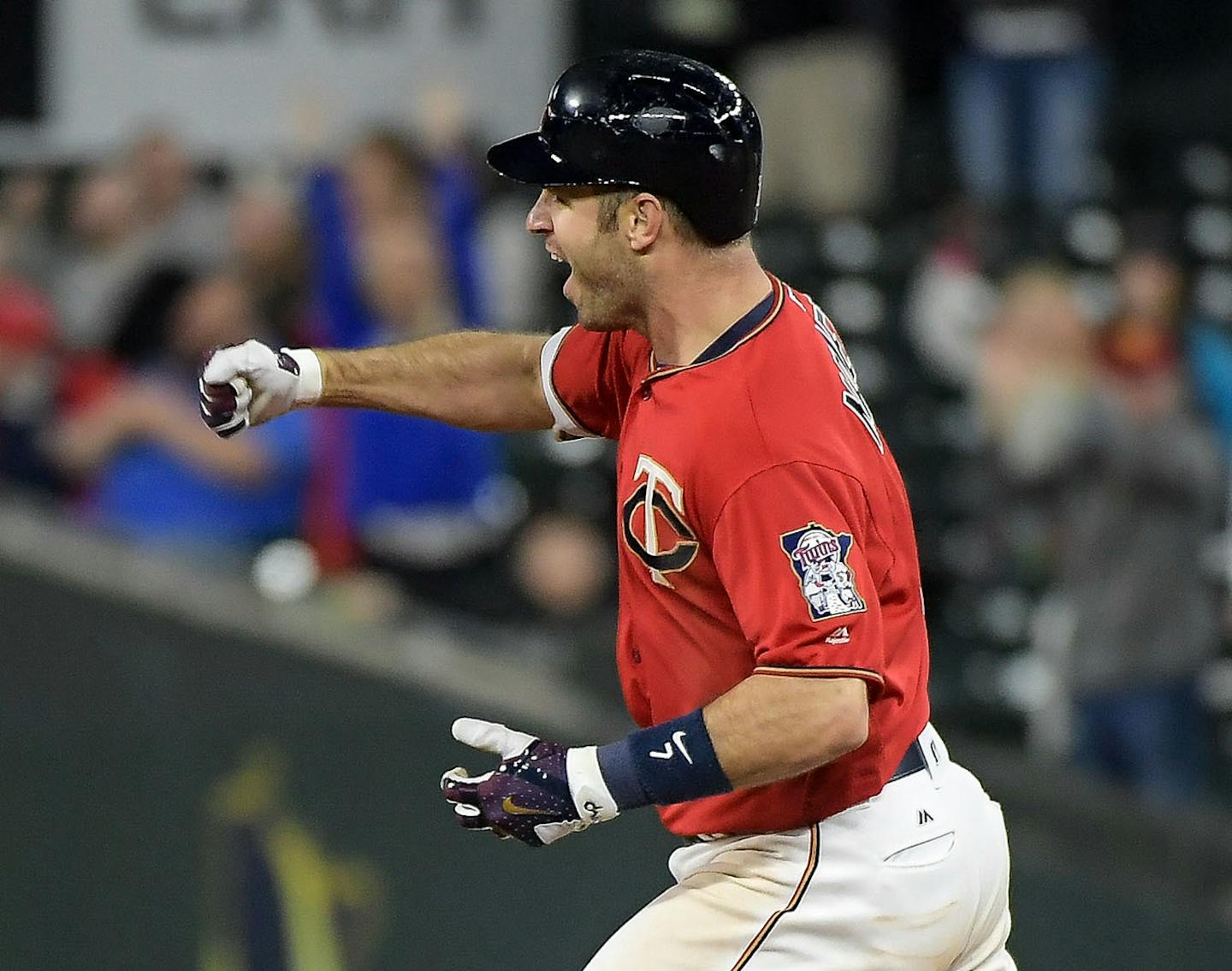 Minnesota Twins first baseman Joe Mauer (7) celebrated while rounding the bases after he hit a walk off homerun against the Boston Red Sox.