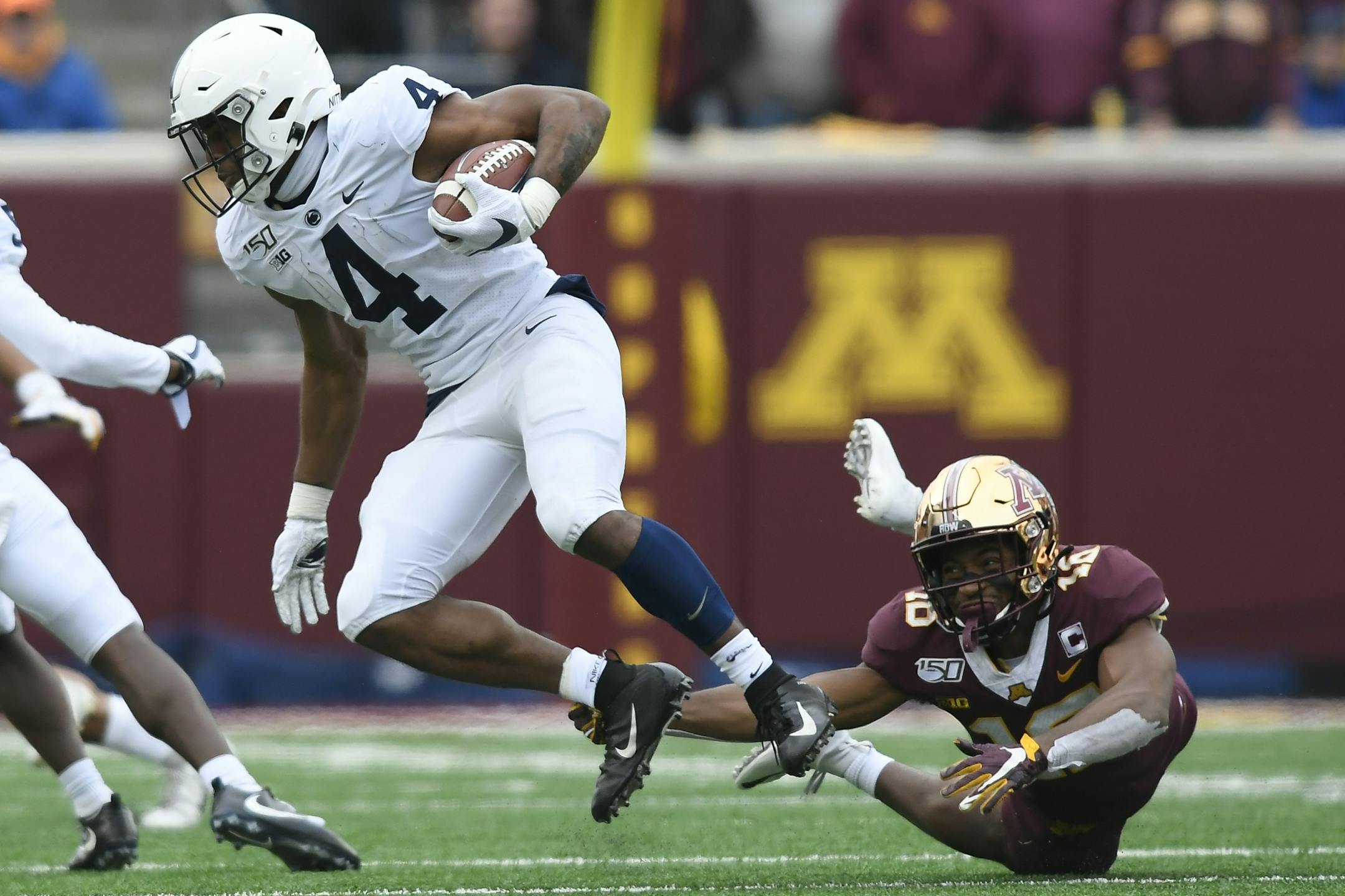 Minnesota Gophers defensive back Coney Durr (16) tripped up Penn State Nittany Lions running back Journey Brown (4) in the second half.