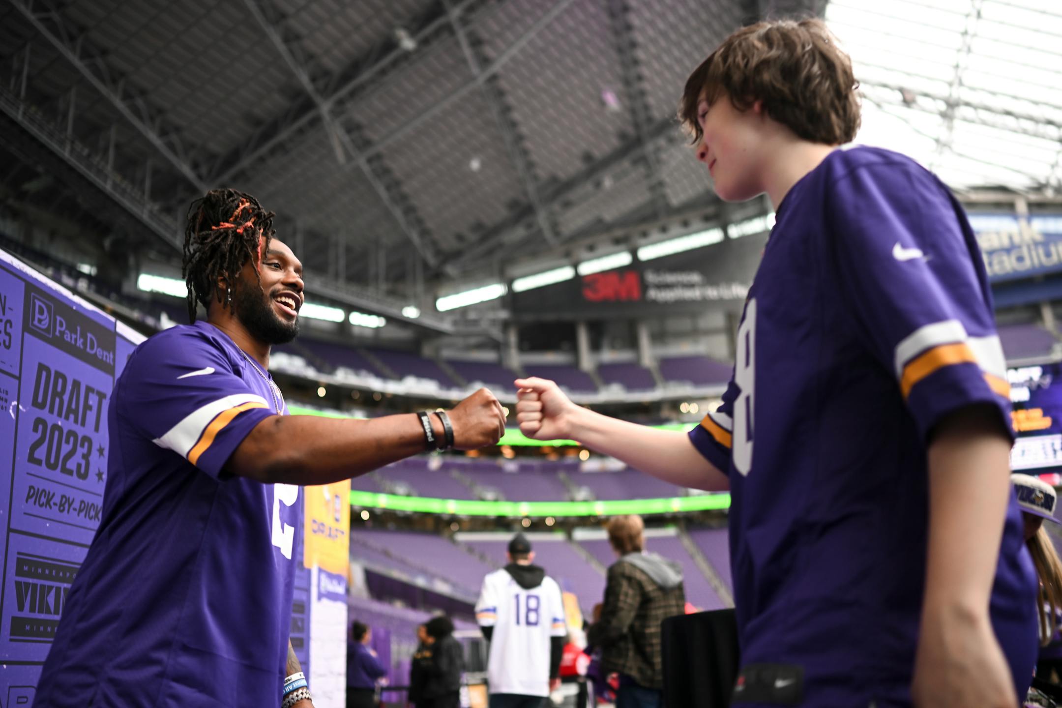 Minnesota Vikings running back Alexander Mattison bumps fists with a young fan before taking a photo during the Vikings NFL Draft Party Thursday night at U.S. Bank Stadium in Minneapolis.