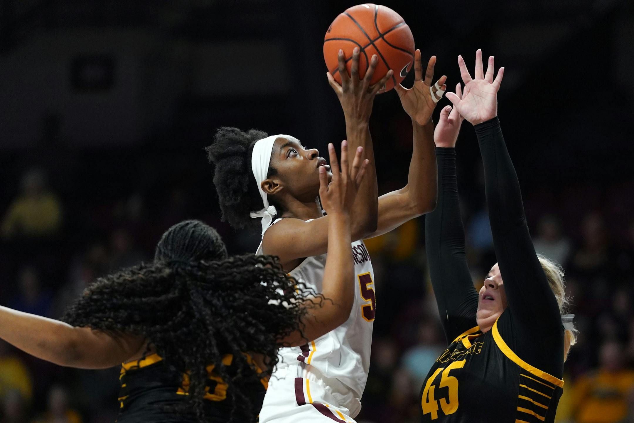 Minnesota Golden Gophers forward Taiye Bello (5) went up for a shot as Milwaukee Panthers forward Lizzie Odegard (45) defended in the first half.
