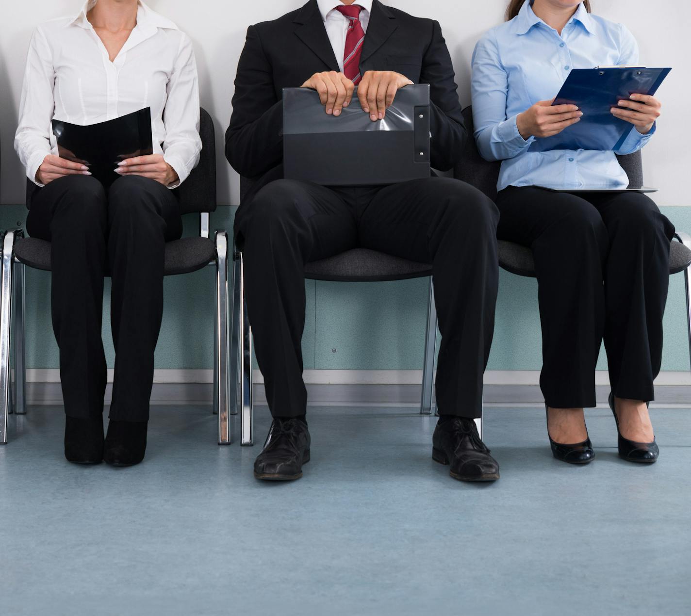 Close-up Of Businesspeople With Files Sitting On Chair