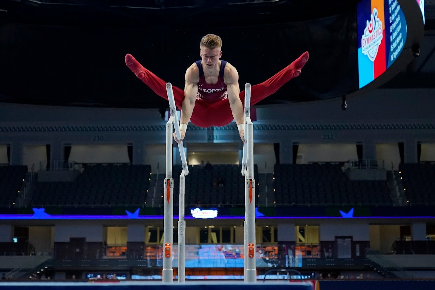 Shane Wiskus competes on the parallel bars during the U.S. Gymnastics Championships, Saturday, June 5, 2021, in Fort Worth, Texas. (AP Photo/Tony Gutierrez)