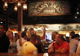 Cowboy Jack�s Bar in Plymouth, MN. Folks chatting at the bar on a Friday night.