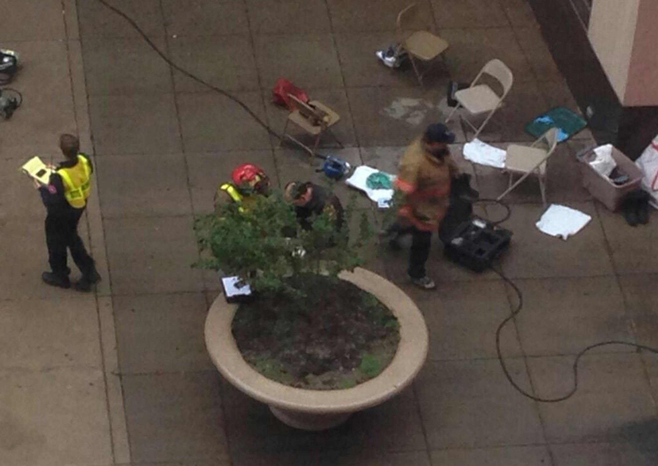 Officials investigate a suspicious envelope found outside the City Hall and County Courthouse building in downtown St. Paul on Wednesday, Oct. 30, 2013.