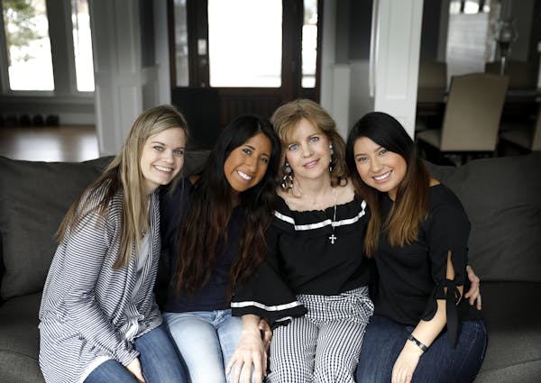 Julie Ledy, second from right, founder of the nonprofit "Adoption is Love" poses for a photo with her daughters Jenna Huiras, from left, 29, Chloe Led