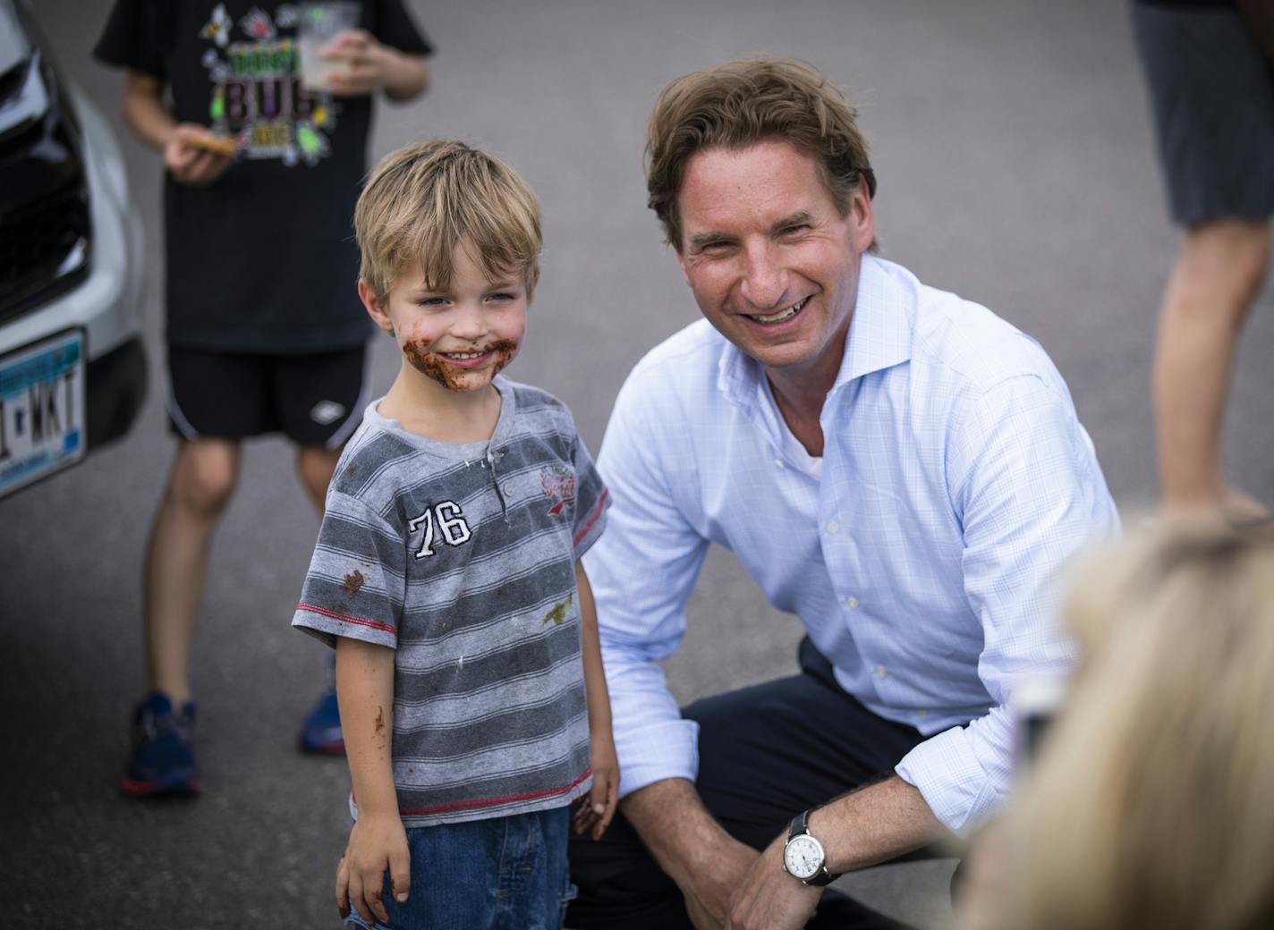 Dean Phillips poses for a photo with Adam Soebbling, 4, of Golden Valley at Music in Plymouth. ] LEILA NAVIDI &#xef; leila.navidi@startribune.com BACKGROUND INFORMATION: Dean Phillips, democratic candidate for Minnesota&#xed;s Third District congressional seat, campaigns during the Music In Plymouth event on Wednesday, July 11, 2018.