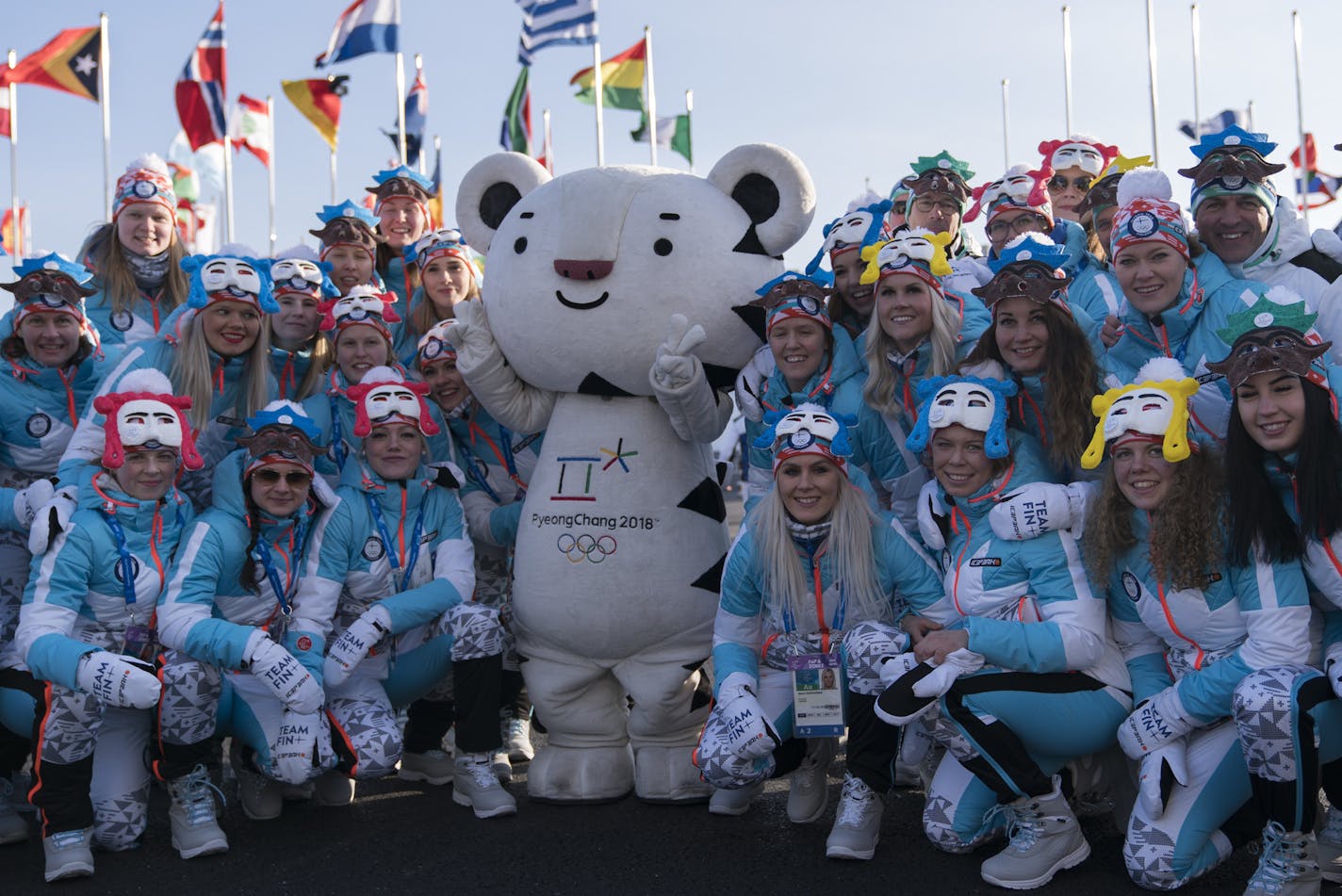 Members of the Finland Olympic Team pose for photos with the Olympic mascot at the end of a welcome ceremony inside the Gangneung Olympic Village prior to the 2018 Winter Olympics in Gangneung, South Korea, Wednesday, Feb. 7, 2018. (AP Photo/Felipe Dana)