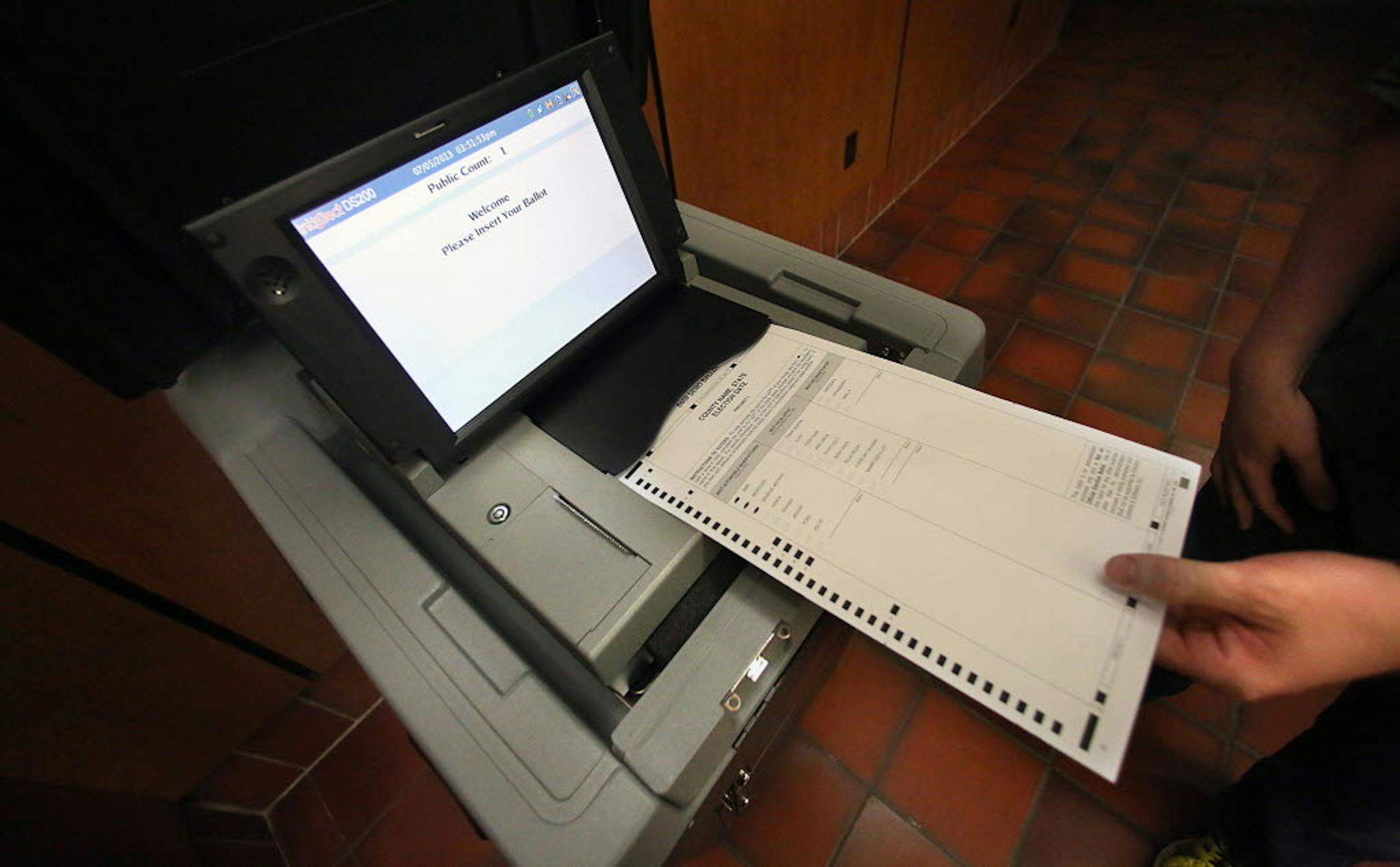 Hennepin County Elections worker Luke Belant demonstrated how a ballot will be cast in a new generation of election machines (this one on display at the Hennepin County Government Center).