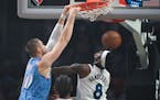 Clippers center Ivica Zubac dunked over Wolves forward Jarred Vanderbilt during the first half Saturday night in Los Angeles.