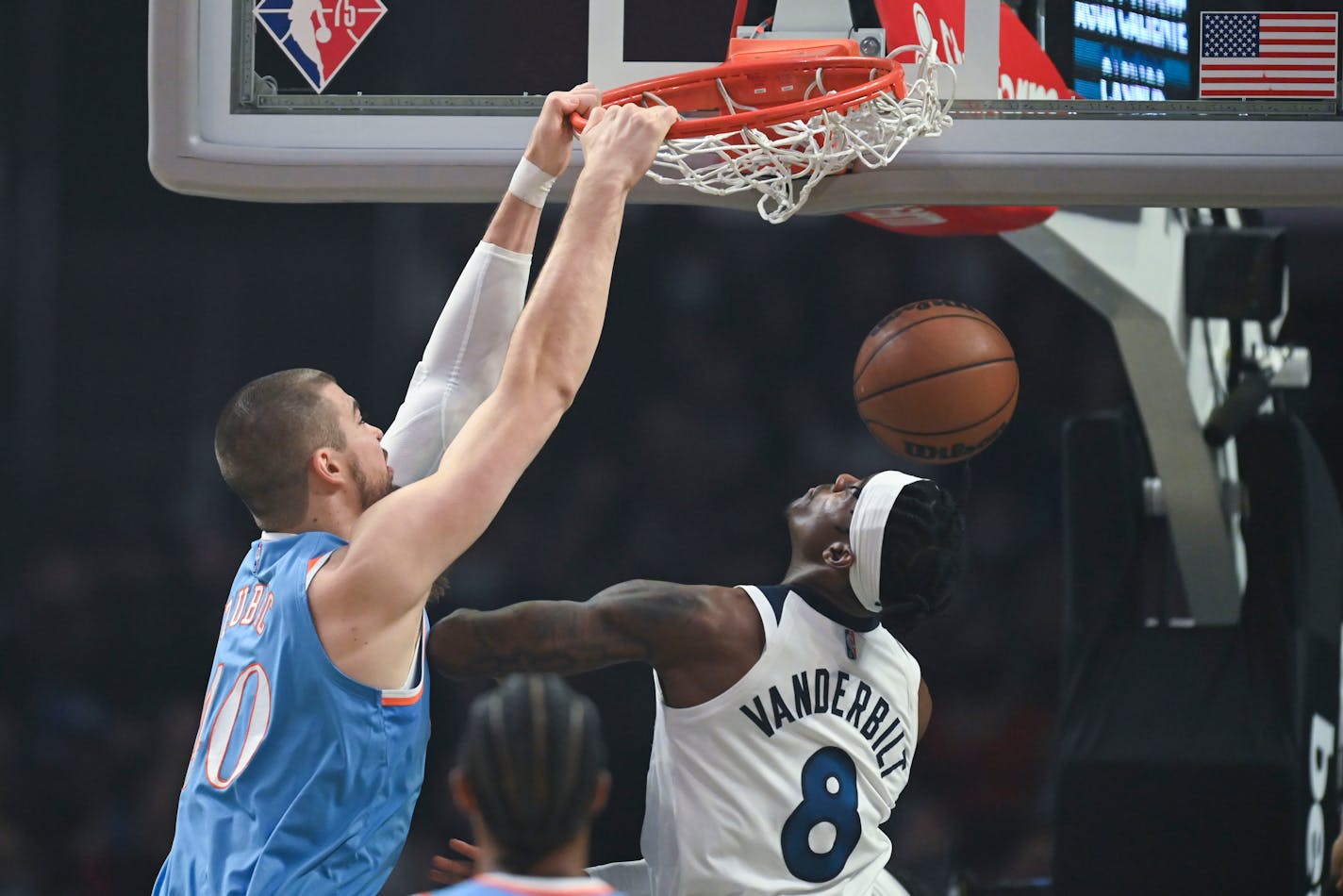 Clippers center Ivica Zubac dunked over Wolves forward Jarred Vanderbilt during the first half Saturday night in Los Angeles.