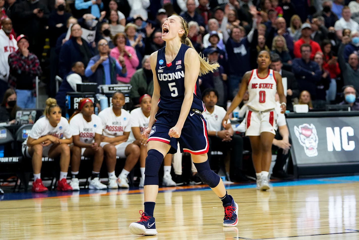 Connecticut guard Paige Bueckers (5) reacts in double overtime against NC State during the East Regional final college basketball game of the NCAA women's tournament, Monday, March 28, 2022, in Bridgeport, Conn. (AP Photo/Frank Franklin II)