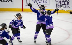 Teammates celebrate with Frost forward Katy Knoll, right, after she scored to win the game in triple overtime Saturday at Xcel Energy Center.