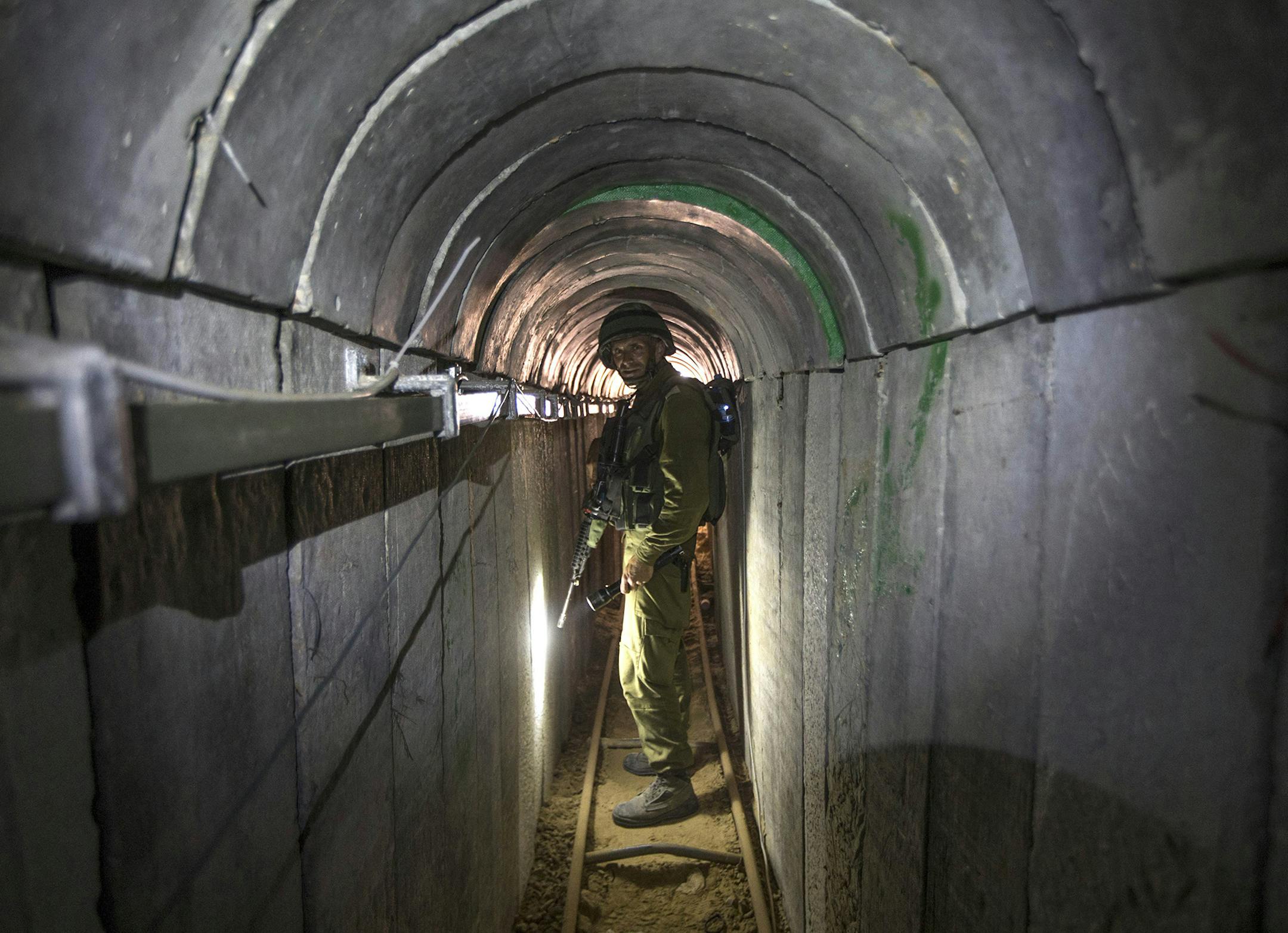 FILE - In this Friday, July 25, 2014 file photo, an Israeli army officer gives journalists a tour of a tunnel allegedly used by Palestinian militants for cross-border attacks, at the Israel-Gaza Border. Hamas is entering Egyptian-brokered talks with Israel over a new border regime for blockaded Gaza having lost hundreds of fighters, two-thirds of its arsenal of rockets, and its attack tunnels. (AP Photo/Jack Guez, Pool, File) ORG XMIT: MIN2014080613121432