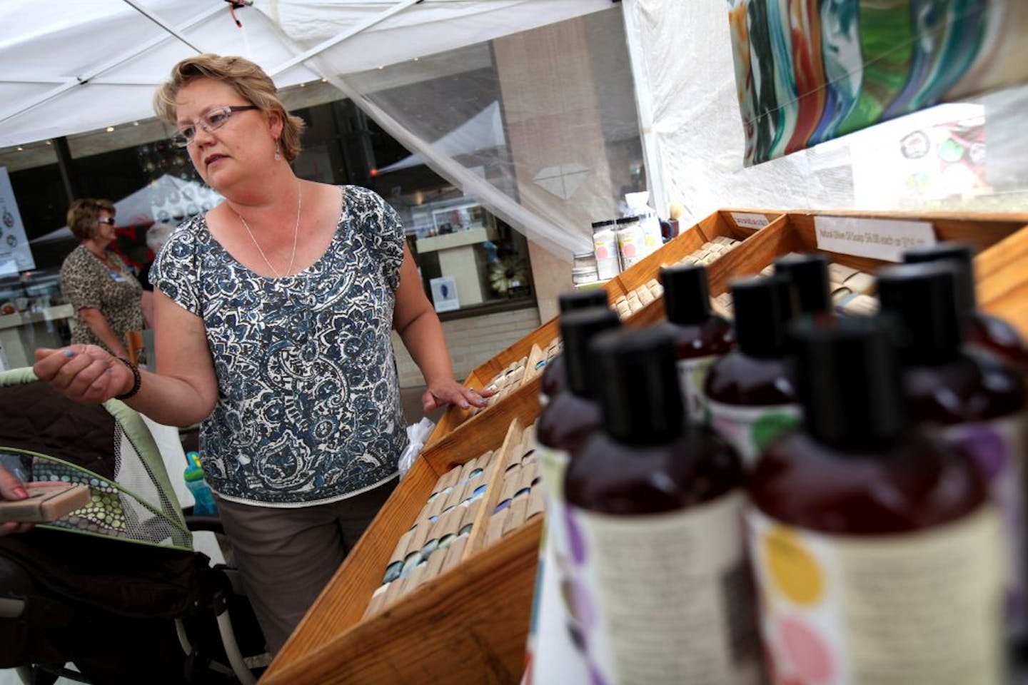 Amy Brooks of "Bubbles by Brooks" waited for shoppers to stop at her tent Thursday June 28, 2012 in Rochester, MN. Rooks of Rochester , sells soaps that are designed to reduced skin irritation to cancer patients as they go through therapy.