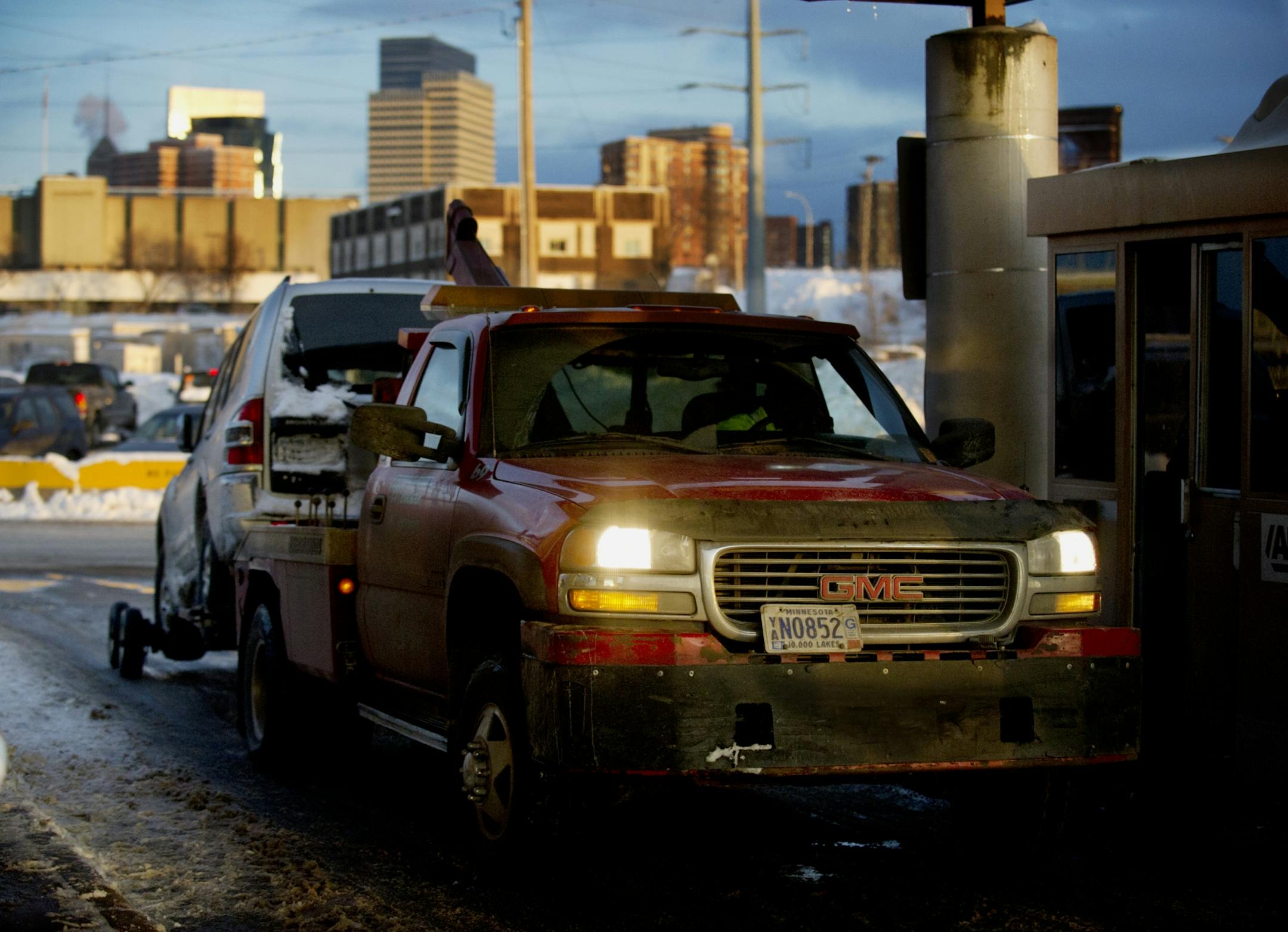 File photo: A vehicle enters the Minneapolis Impound Lot behind a tow truck.
