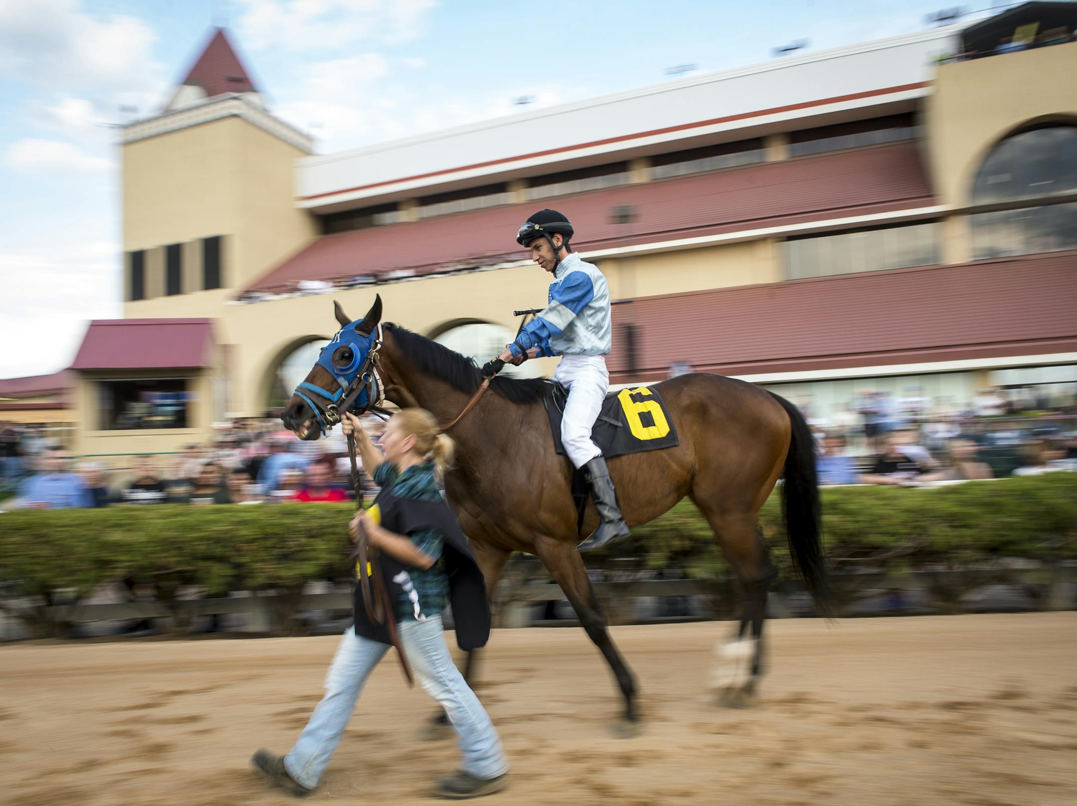 A groom led Alex Canchari, riding Benny's Babygirl, from the paddock to the track before the start of the first race Friday. ] (AARON LAVINSKY/STAR TRIBUNE) aaron.lavinsky@startribune.com The racing season kicked of at Canterbury Park on Friday, May 20, 2016 in Shakopee, Minn. ORG XMIT: MIN1605202017450106