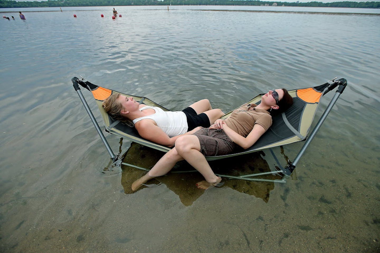 Like many escaping the day's heat, Miranda Ebner, left, and Samantha Abbott, right, took to the water to keep cool at Lake Harriett earlier this summe
