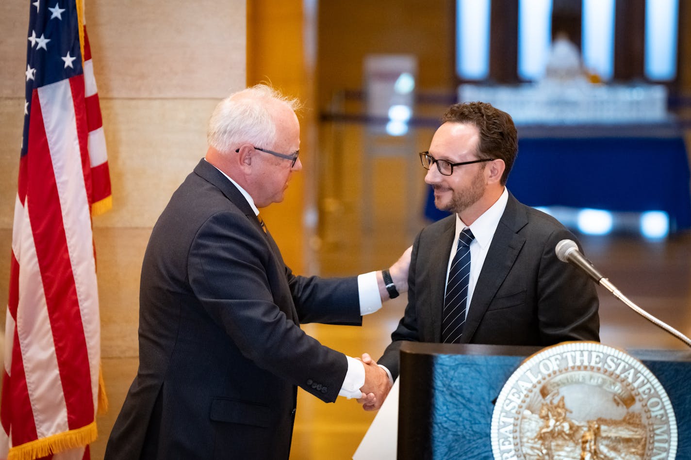 Gov. Tim Walz shook hands with Karl Procaccini, who will become an associate justice of the Minnesota Supreme Court.