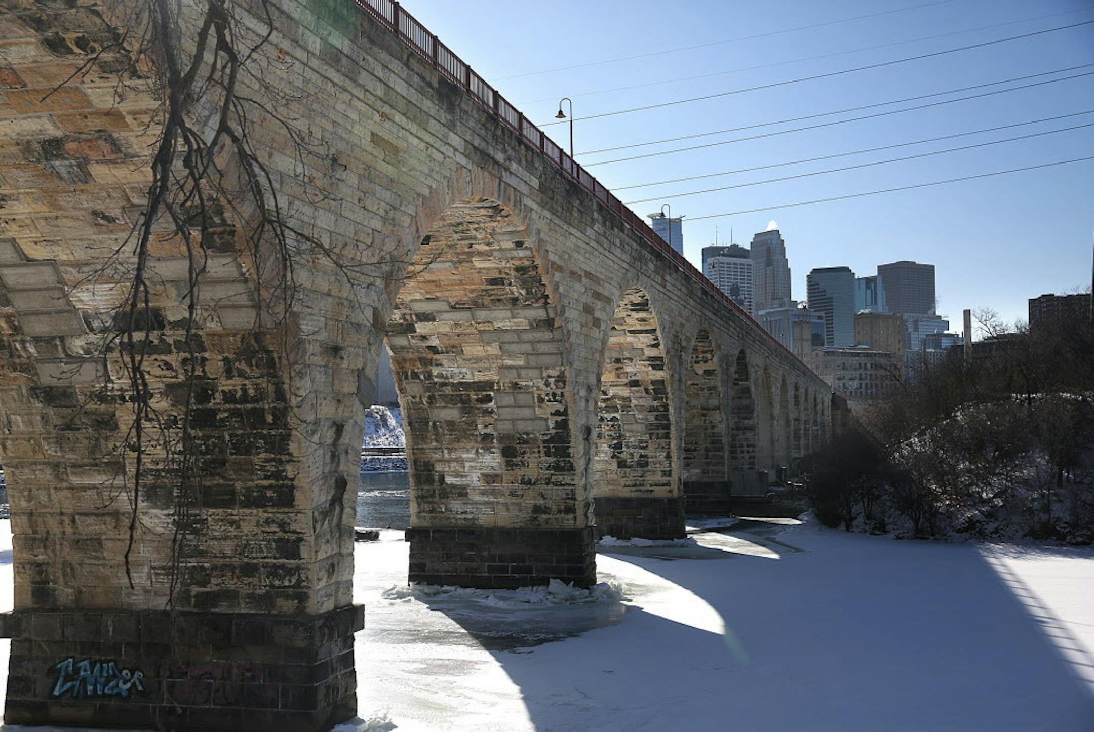 The Minneapolis skyline provides a picturesque backdrop for the historic Stone Arch Bridge, along the Mississippi River. ] JIM GEHRZ &#xef; james.gehrz@startribune.com / Minneapolis, MN / March 5, 2015 /2:30 PM &#xf1; BACKGROUND INFORMATION: More than 30 years since a foundational plan for riverfront park development prompted huge changes in the St. Anthony Falls area, a new plan takes stock of what's undone, urges correcting what was done wrong and adds new ideas.