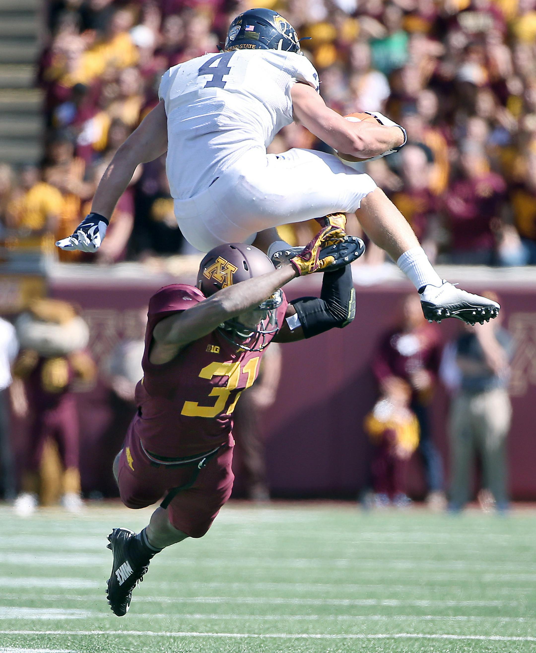 Kent State running back Nick Holley hurdled Minnesota's defensive back Eric Murray in the fourth quarter as the Gophers took on Kent State at TCF Bank Stadium, Saturday, September 19, 2015 in Minneapolis, MN. ] (ELIZABETH FLORES/STAR TRIBUNE) ELIZABETH FLORES &#x2022; eflores@startribune.com