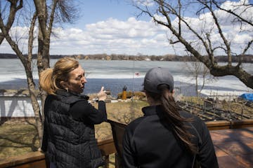 Melissa Hanson, left, shows Meghan Darley, a resource conservation technician with Scott Soil & Water Conservation District, the part of her lakeshore