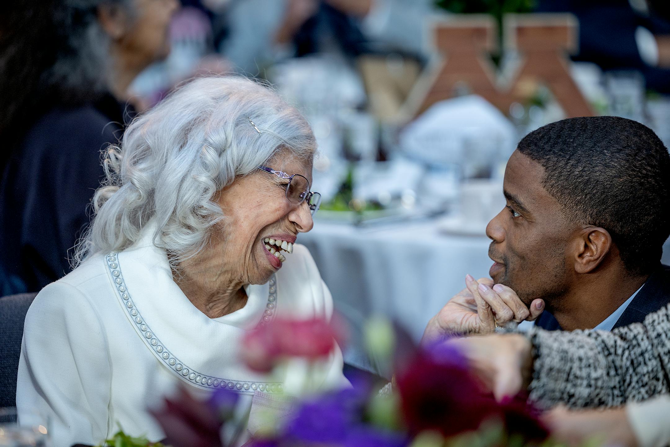 Josie R. Johnson grabs a hold of St. Paul Mayor Melvin Carter as he greets her at a ceremony honoring her in Minneapolis.