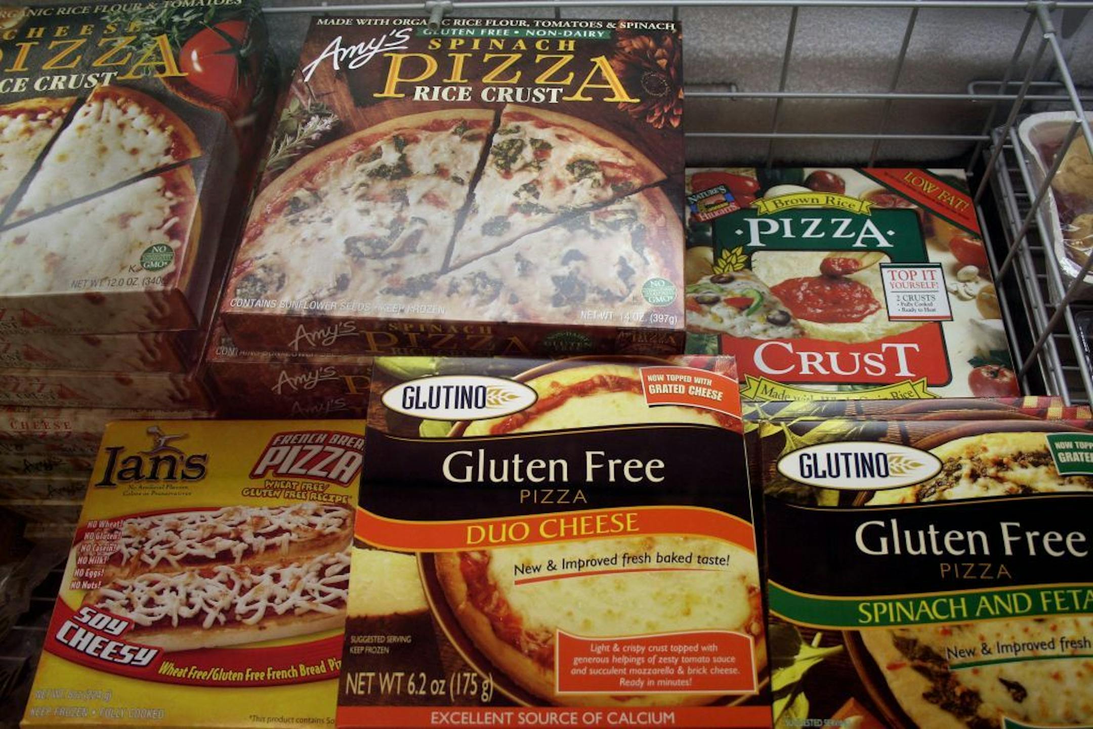 FILE - This Nov. 11, 2008, file photo, shows gluten-free frozen pizza, just one of hundreds of items at Gluten Free Trading Co. in Milwaukee. Schools, restaurants and anyone else serving food are more vulnerable to legal threats over food sensitivities after the Justice Department determined that severe food allergies can be classified as disabilities under federal law. People who suffer from celiac disease don't absorb nutrients well and can get sick from the gluten found in wheat, rye and barl