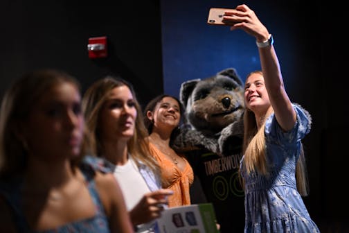 Incoming Maple Grove juniors with the dance team Olivia Nagel, right, and Aubrianna Brown pose for a photo with Minnesota TImberwolves mascot "Crunch" before the Star Tribune's sixth annual All-Metro Sports Awards show.