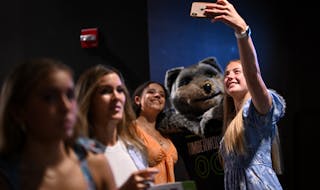 Incoming Maple Grove juniors with the dance team Olivia Nagel, right, and Aubrianna Brown pose for a photo with Minnesota TImberwolves mascot "Crunch"